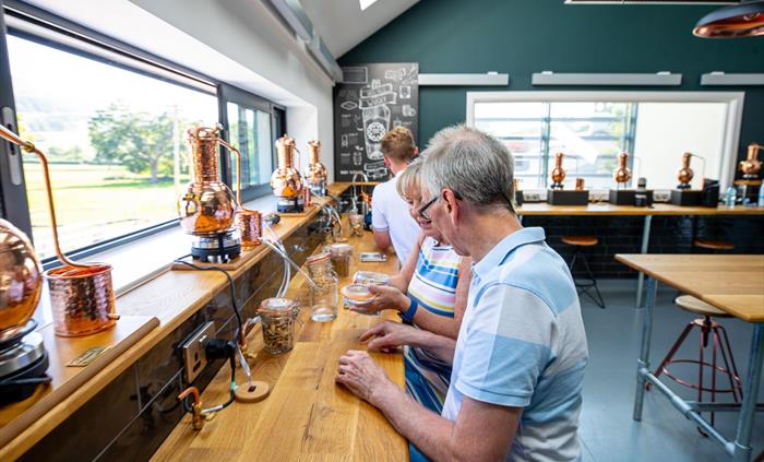 Interior if the Gin Lab at Aber Falls, showing 3 people making gin